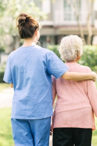 Nurse with arm around elderly woman