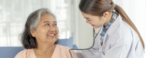 Nurse checks patient with stethoscope